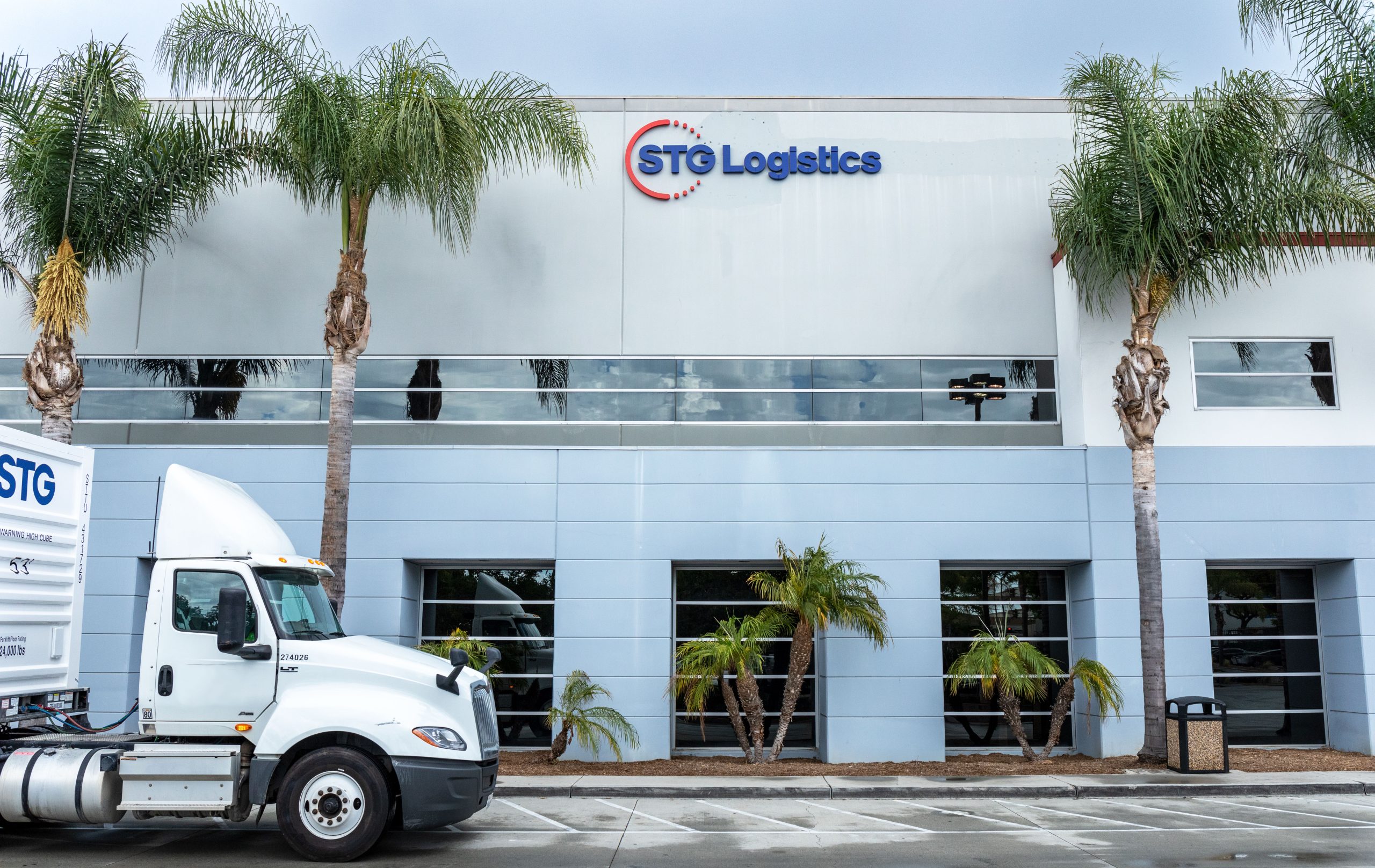 STG Logo on warehouse, STG truck coming up.